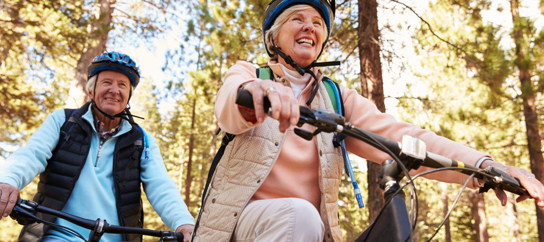 senior couple mountain bike in the woods