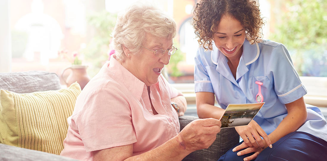 nurse making a house call to an elderly woman