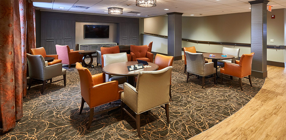 tables and chairs in lounge at luther acres