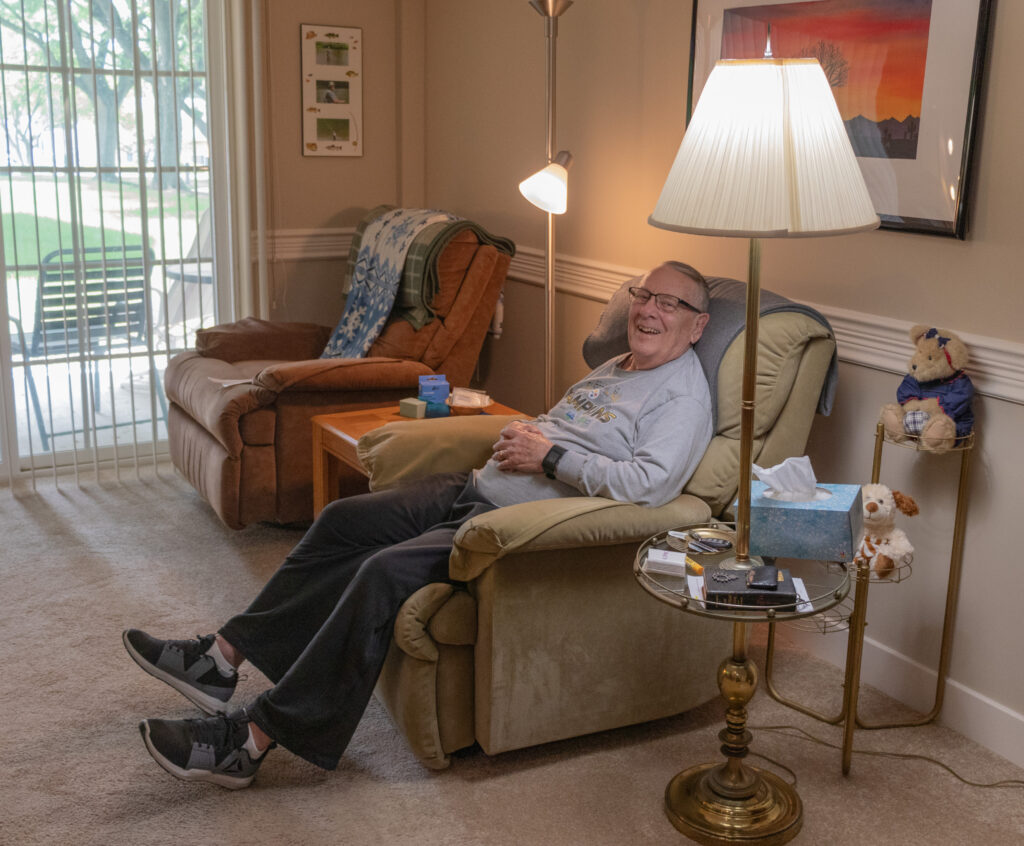 Dave Karl sitting in his apartment.