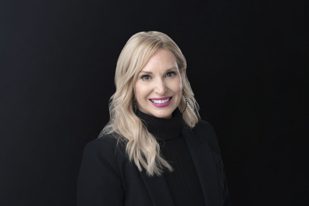 A headshot of Marissa Picchini against a black background
